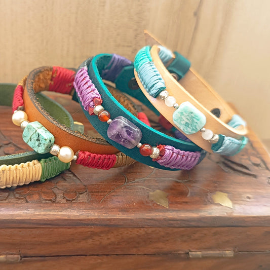 group photo of the Inner Harmony Collection bracelets, resting sideways on a vintage wooden jewelry box.