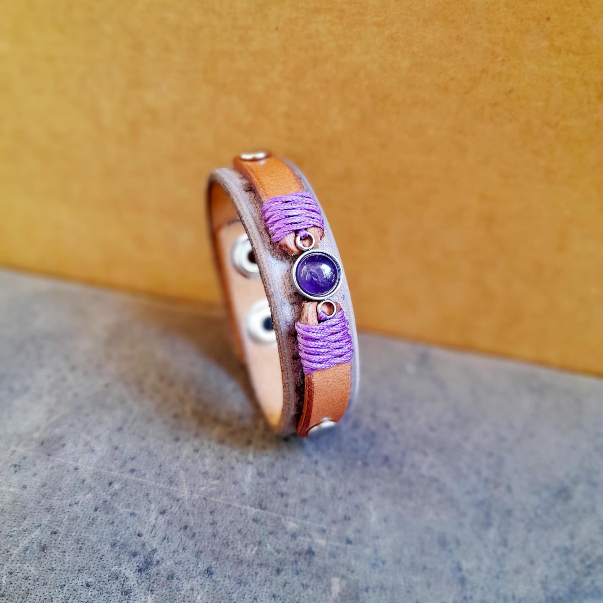 Full view of the Amethyst & Leather Stacking Bracelet, side view, showcasing its entire design, including the leather layers, Amethyst stone, and silver-tone rivets.