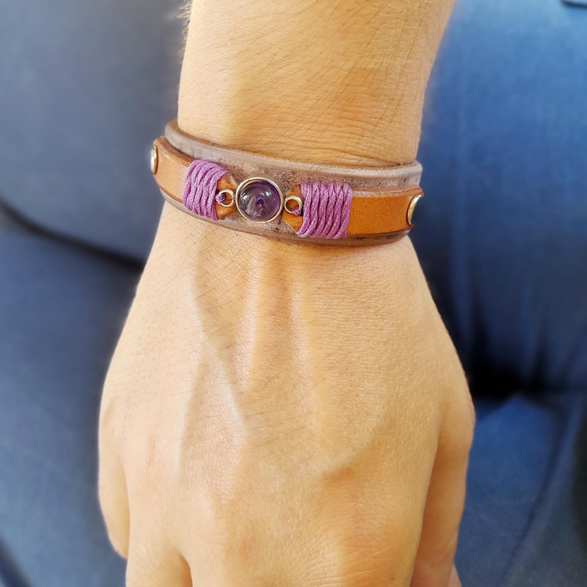 The Amethyst & Leather Stacking Bracelet worn on a wrist, demonstrating its comfortable fit, simple look, and how it can be easily stacked with other bracelets.