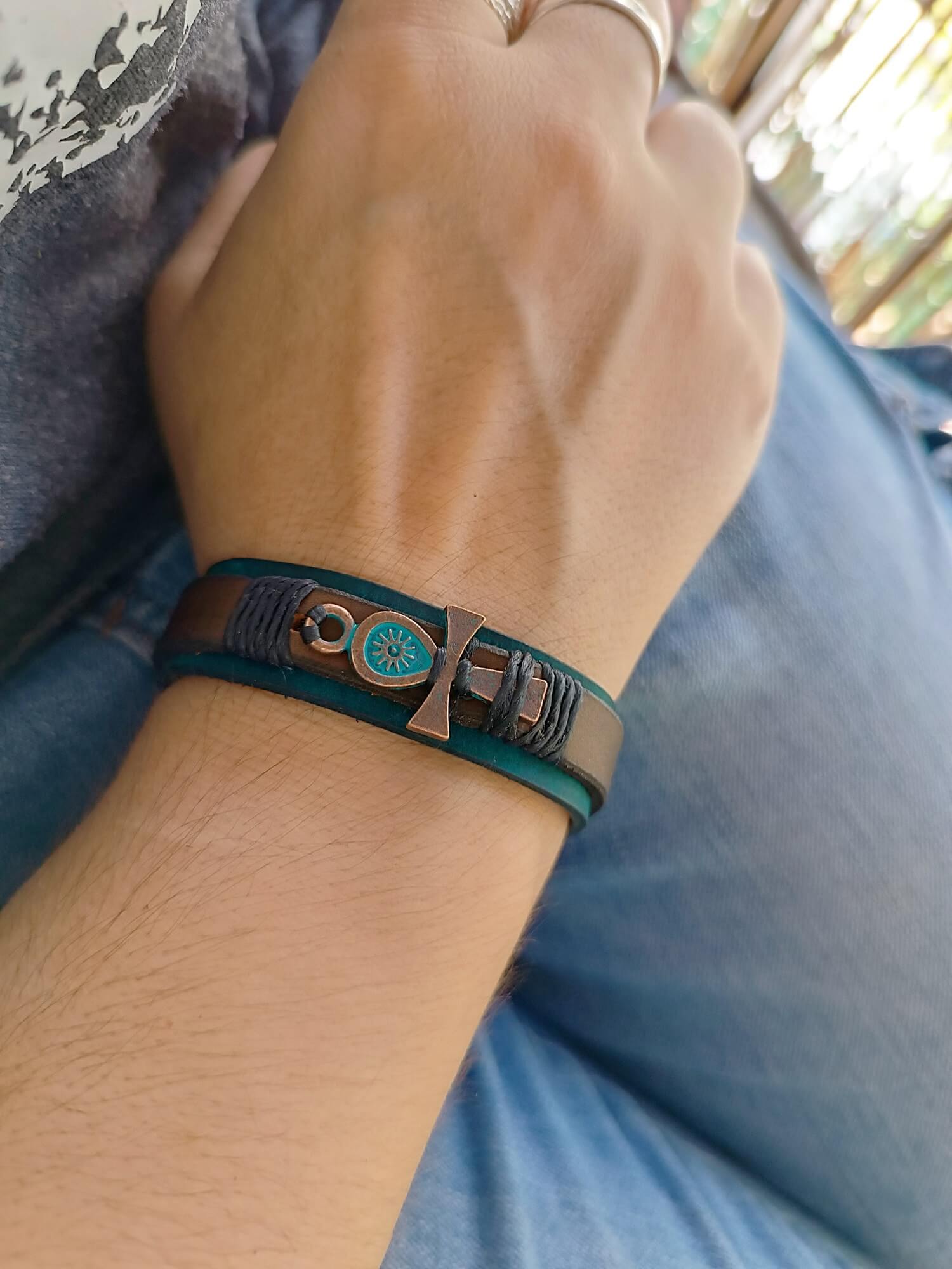 Ankh bracelet worn on wrist, rustic and symbolic design