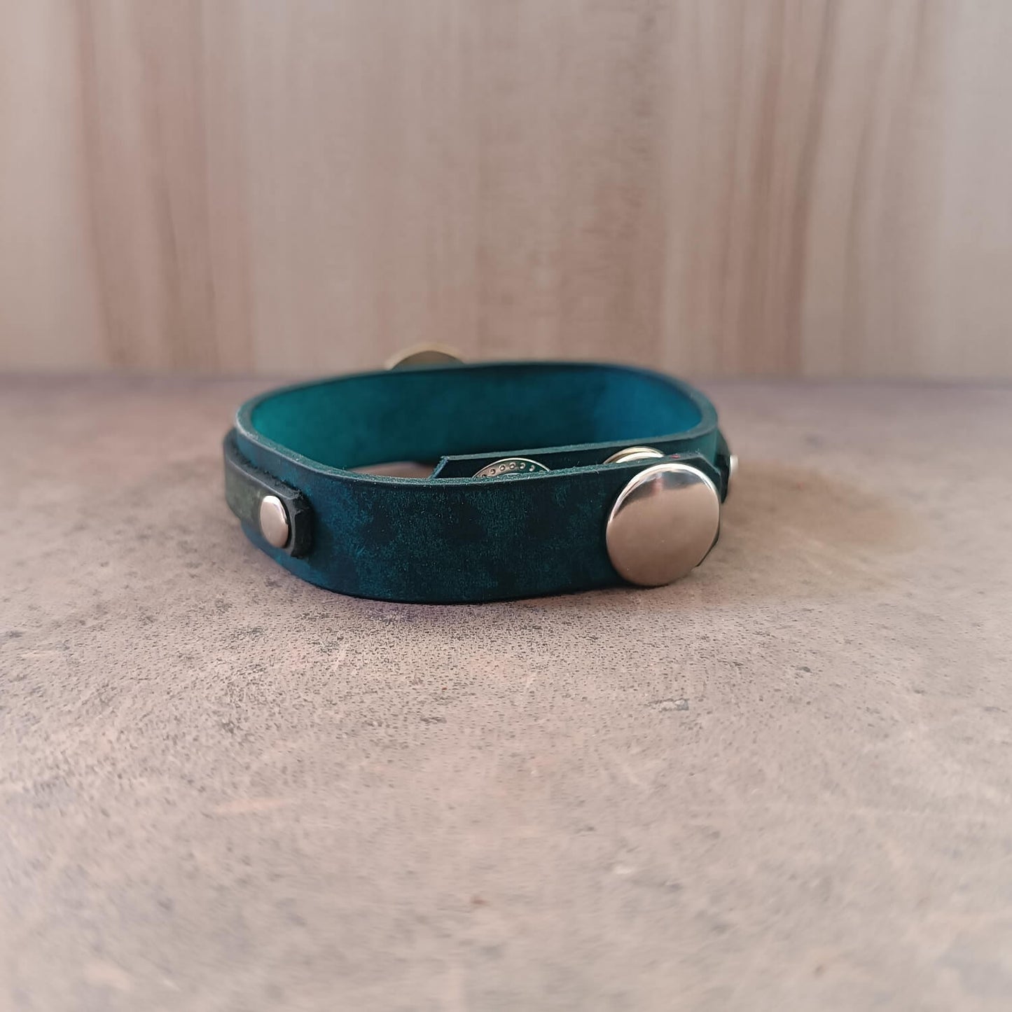 Back of Solar Scarab Bracelet, showing adjustable stainless steel snap buttons closure and soft leather underside.