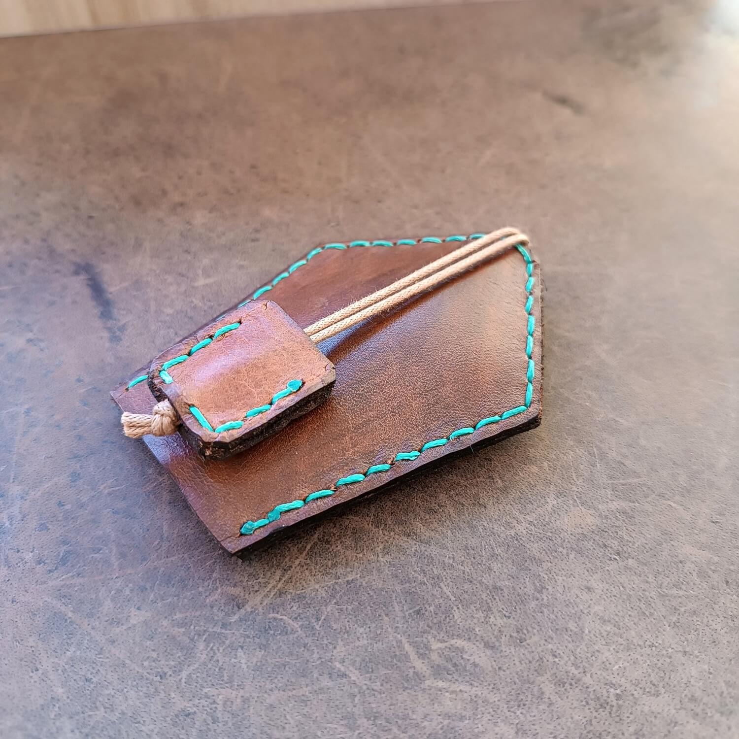 Back view of The Peace Weaver Leather Key Holder, showing the secure stainless steel snap button for attaching to bags, belts, or backpacks.