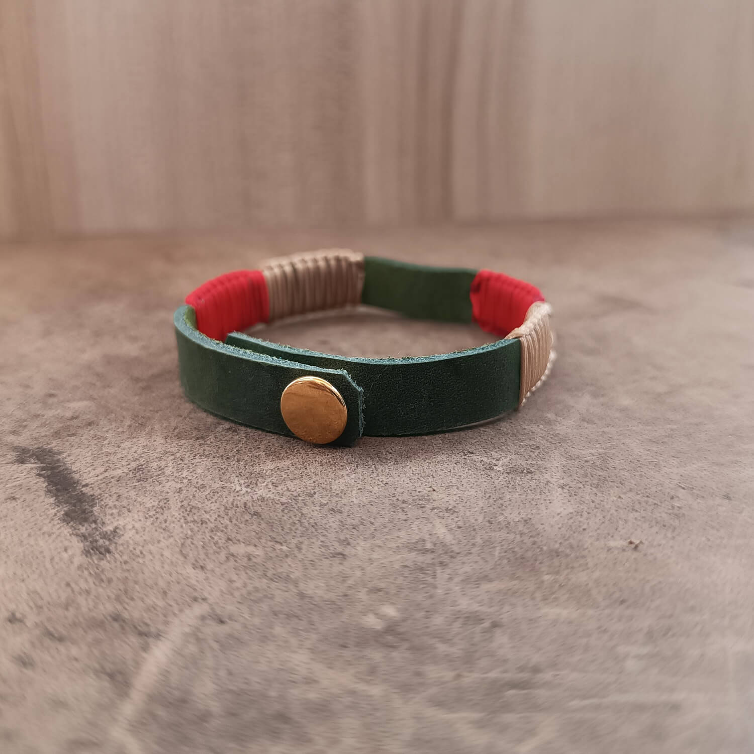 Back view of The Sweet Abundance Watermelon Bracelet, displaying the gold stainless steel snap button closure and the adjustable settings on the green leather band.