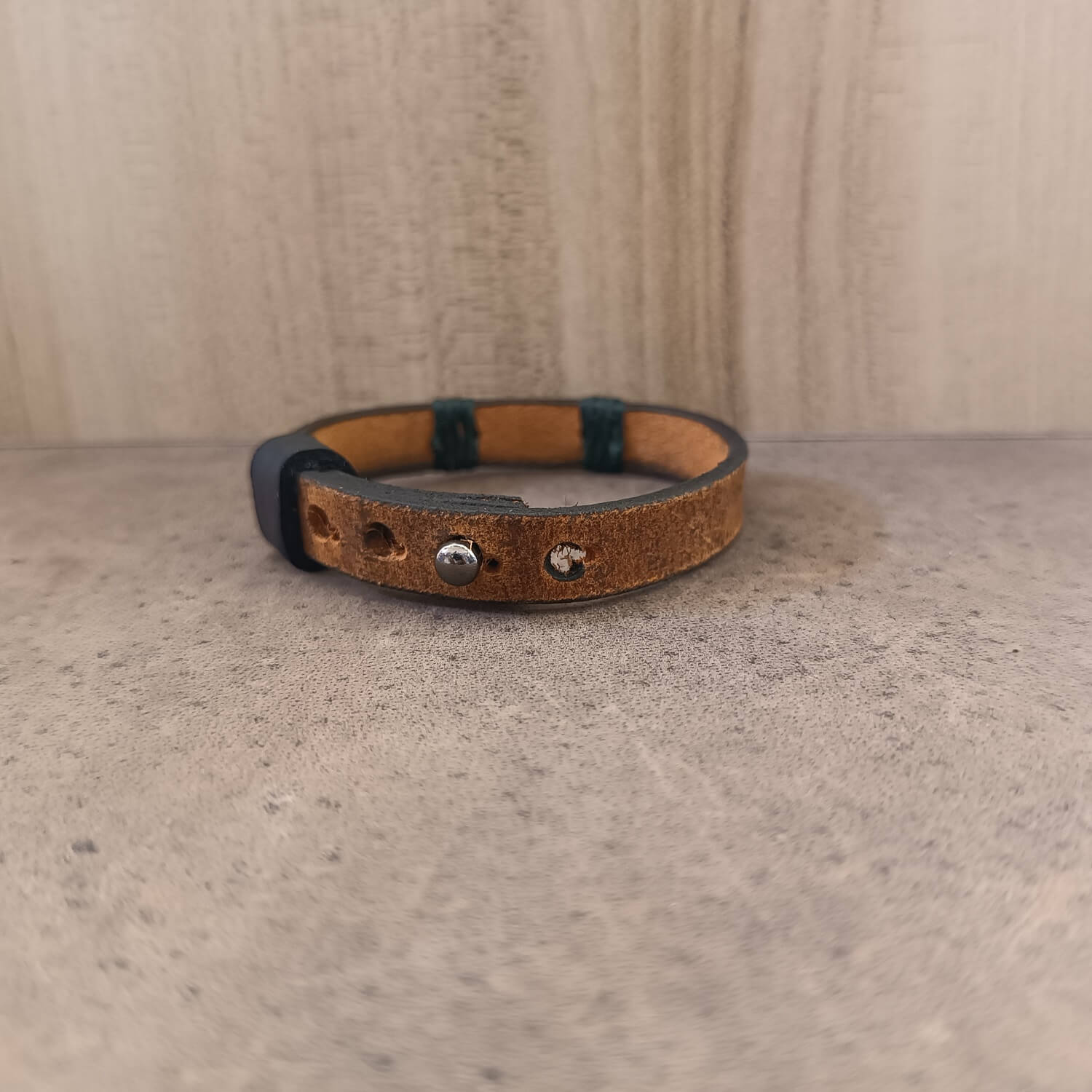 Back view of Minimal Red Garnet Leather Wrap Bracelet, showing the stainless steel stud button closure with multiple adjustment openings on the leather band.