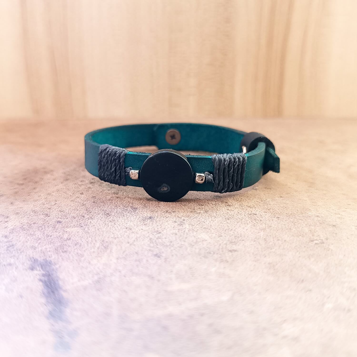 Close up of the Black Agate and petrol blue leather bracelet showing stone and cord wrap