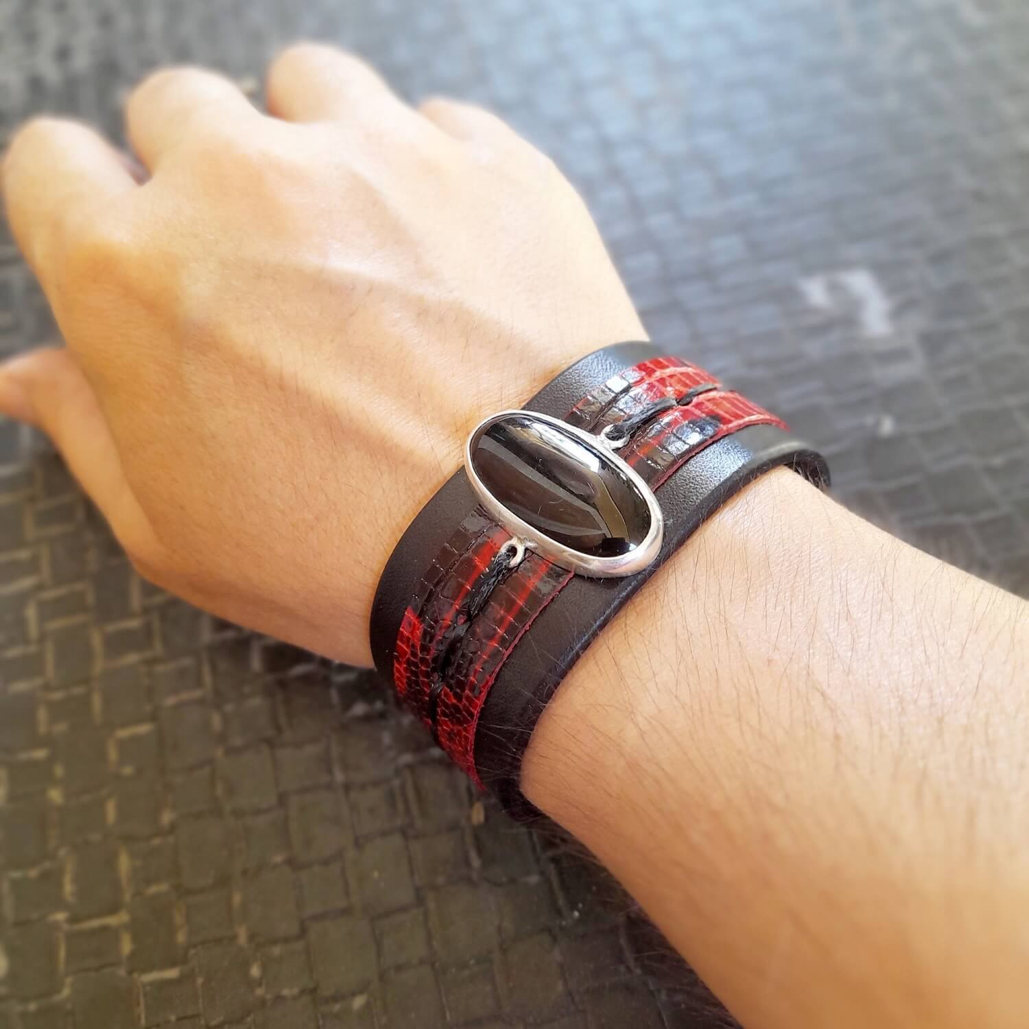 Black Obsidian leather bracelet worn on a wrist, demonstrating fit and bold style.