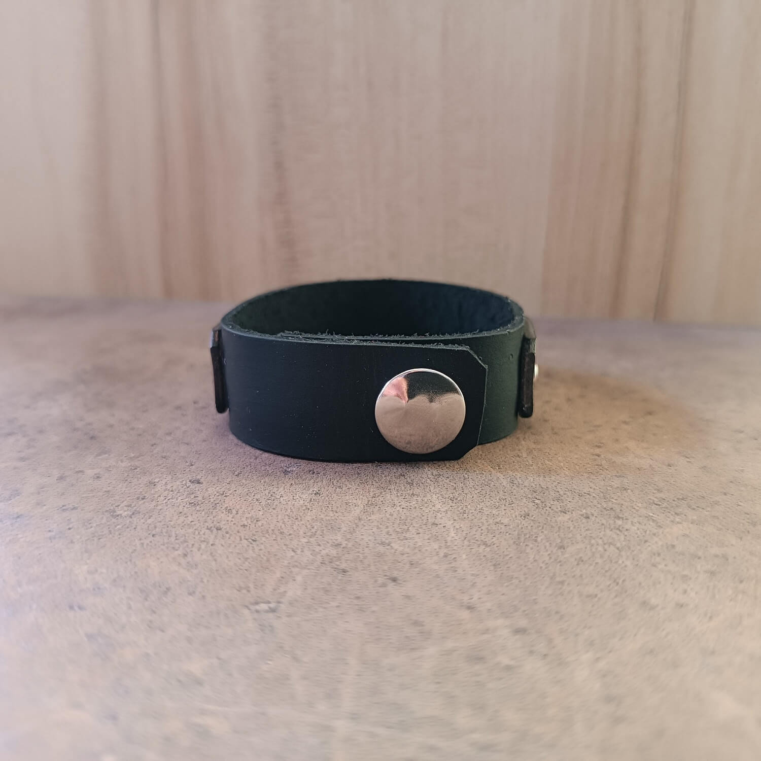 Back view of bracelet showing leather texture and snap closures