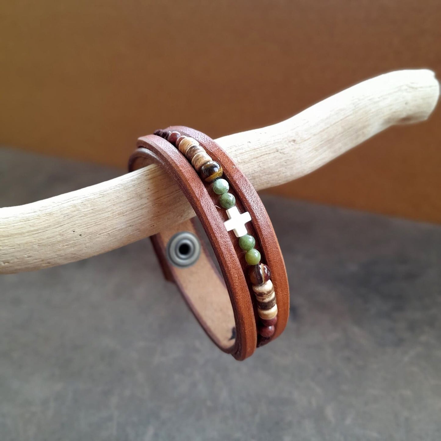 Boho beaded leather bracelet for men with green Jasper, Tiger's Eye, coconut beads, and an ivory cross on brown leather.