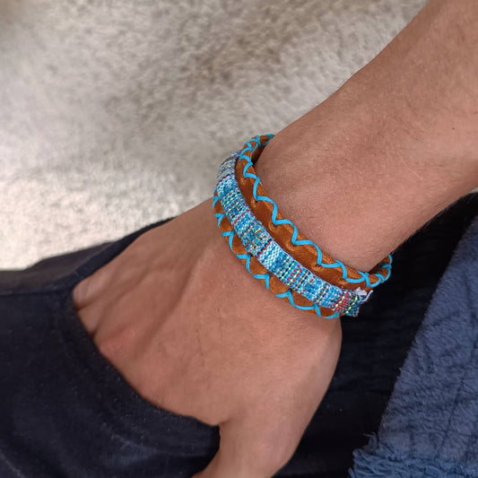 Boho leather bracelet worn on man's wrist, showcasing bold tribal design and rugged unisex styling for casual layering