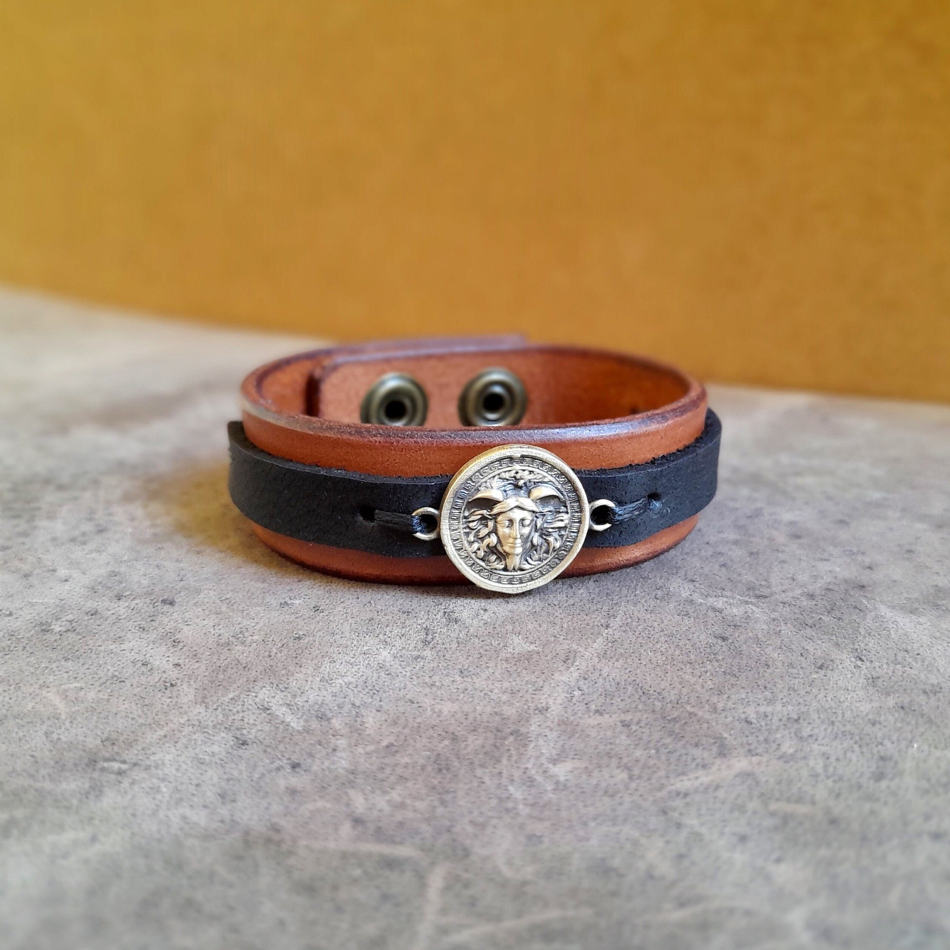 Close-up front view of Greek Medusa Leather Bracelet, focusing on the detailed handcrafted oxidized brass Medusa charm.