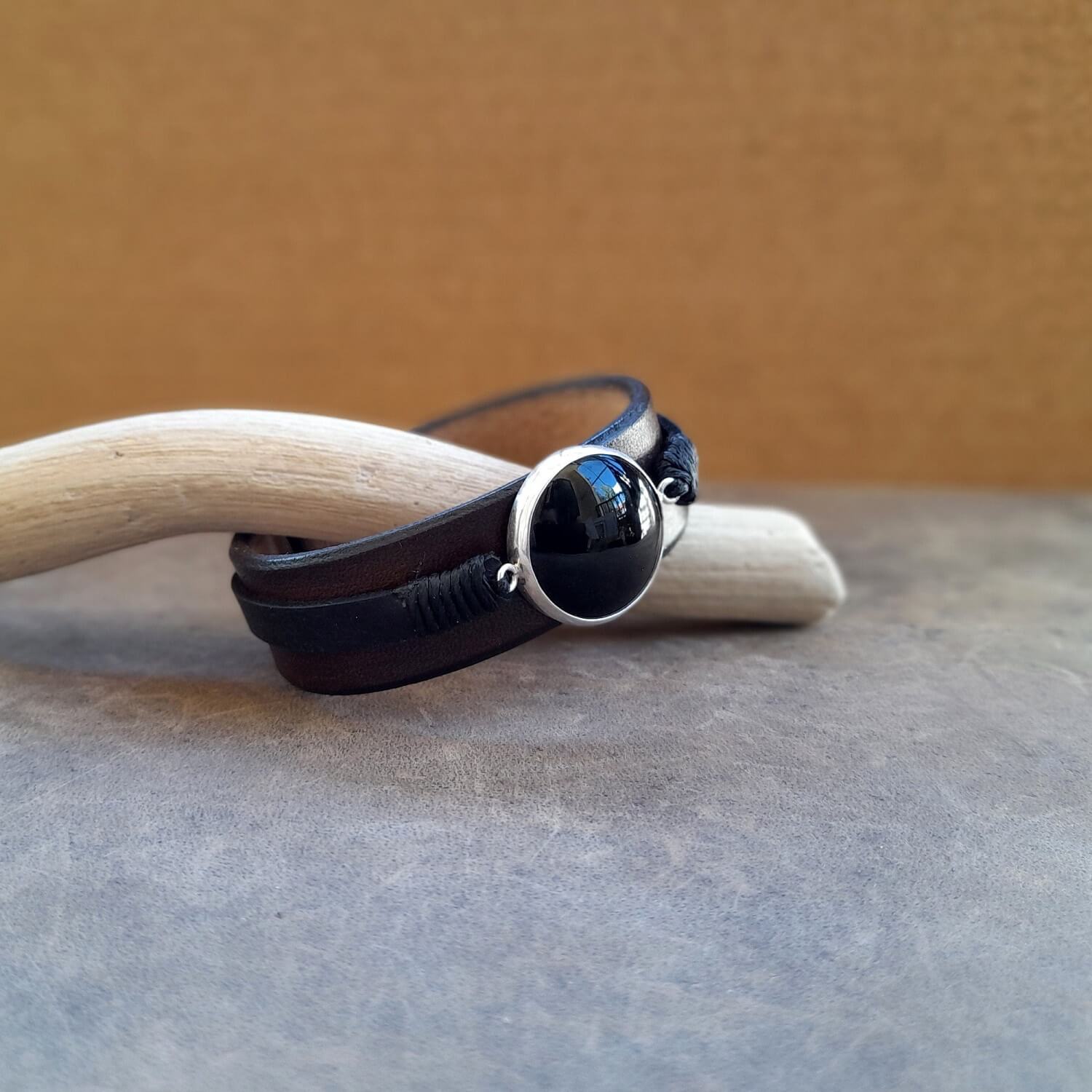Detailed close-up of the large natural black obsidian stone on the cuff, highlighting its deep black color and smooth appearance.