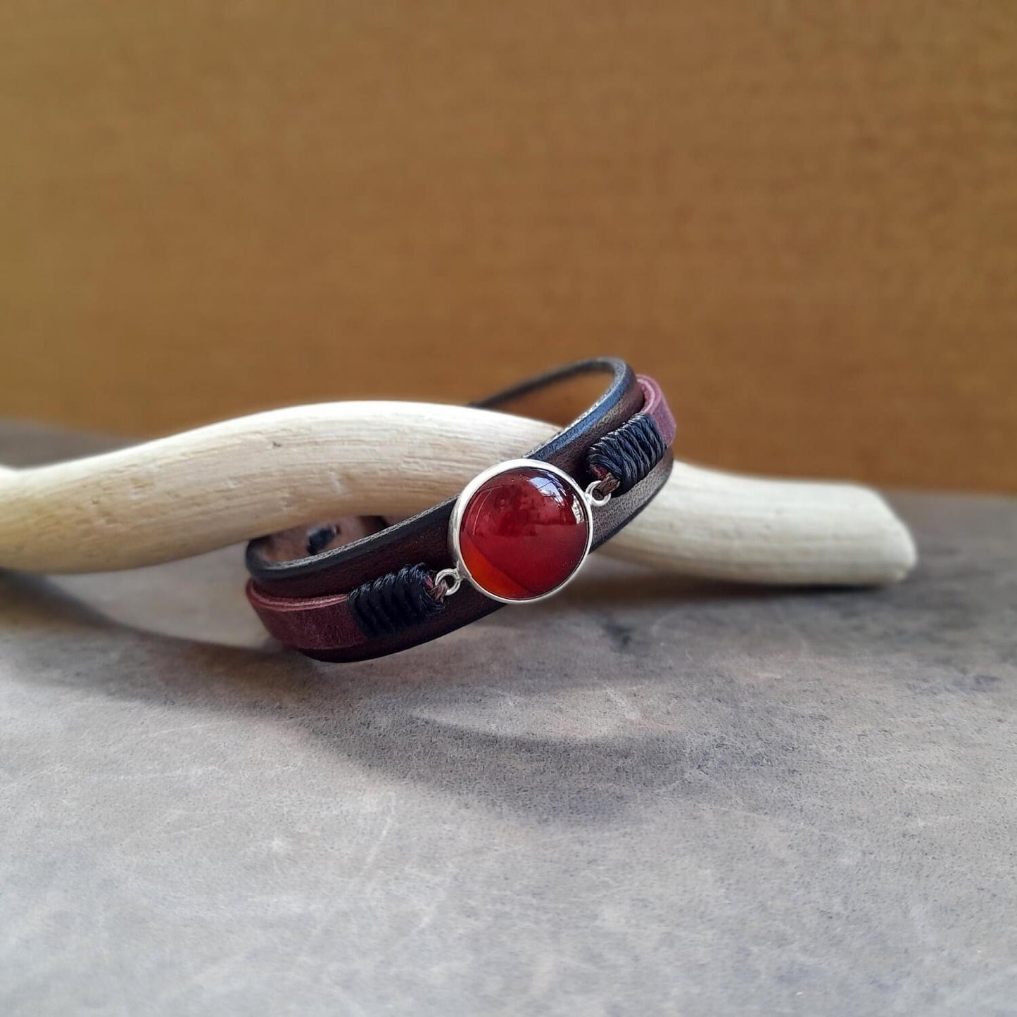 close-up of the natural red Carnelian stone within its handmade polished sterling silver 925 cabochon on the bracelet, highlighting its vibrant color and the silver craftsmanship.