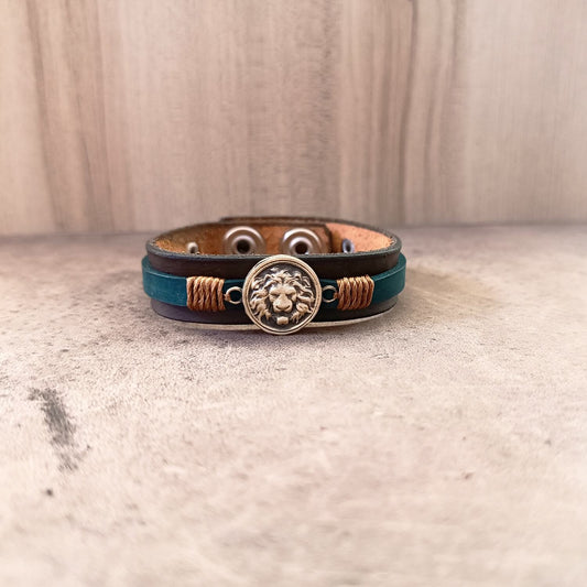 Leather bracelet with lion emblem on a textured surface