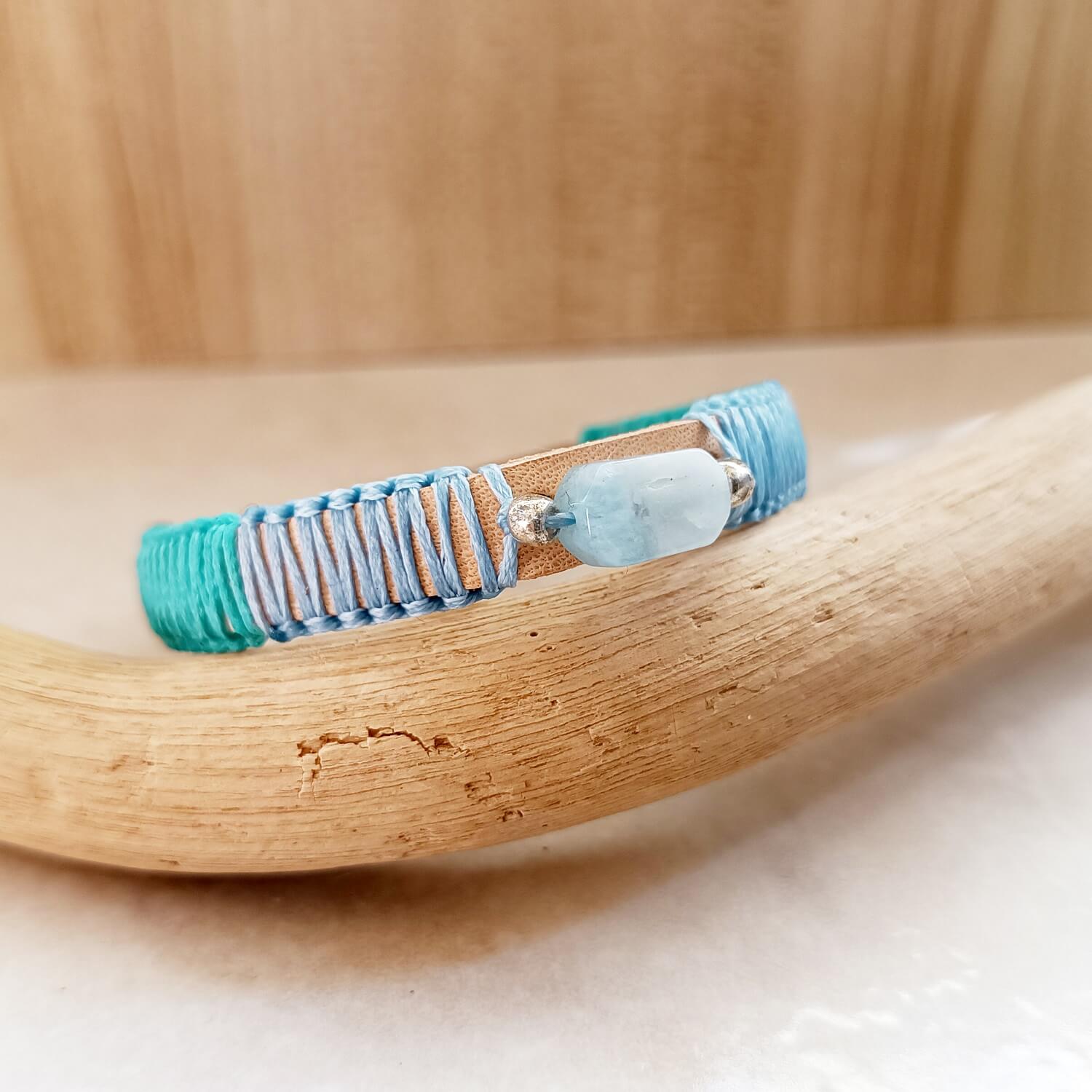 Close-up of Ocean's Embrace bracelet, showing pale blue & seafoam green macrame knotting & Natural Veg Tan Crazy Horse leather texture.