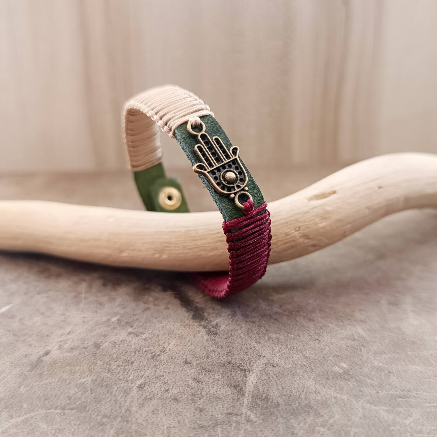 Other Side view of The Hamsa Harmony Bracelet, showing the thickness of the khaki Crazy Horse leather band and the intricate light bronze and burgundy red macrame knotting.