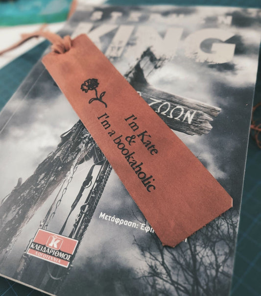 Close-up of frontside Birthflower Leather Bookmark, showing detailed laser engraving of a April's birthflower and clear custom text.