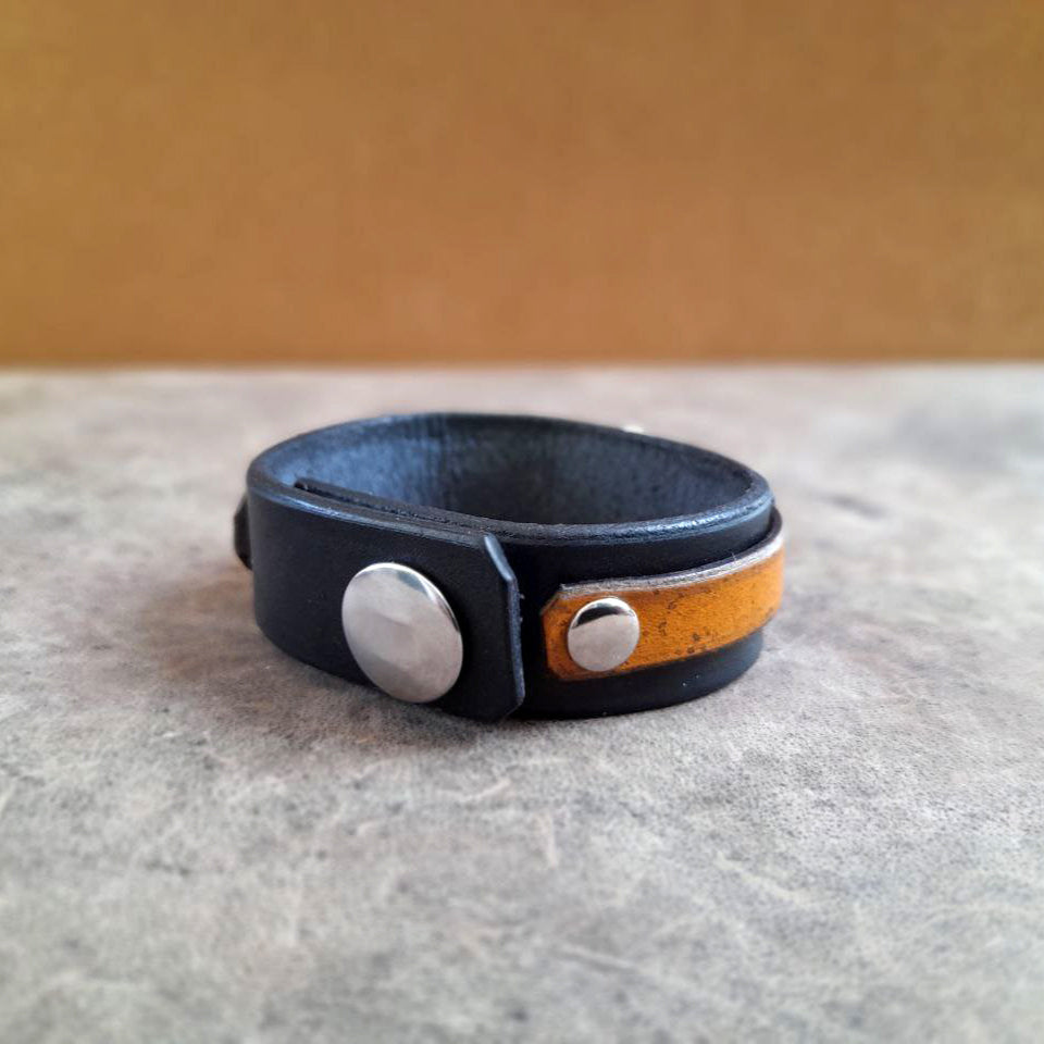 Close-up of the stainless steel snap fastener closure on The Dragon Whisperer Bracelet, demonstrating the adjustable and secure fit.