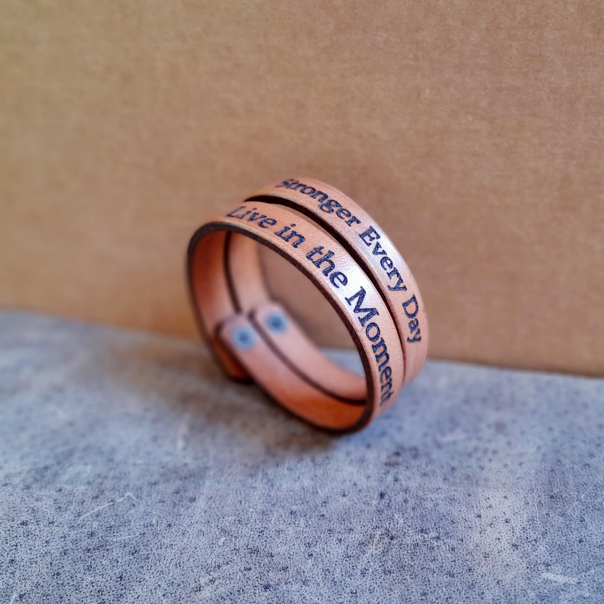 Close-up side view of Personalized Thin Leather Bracelet in mustard brown, highlighting the texture of the full-grain leather and the detail of the custom engraved text.