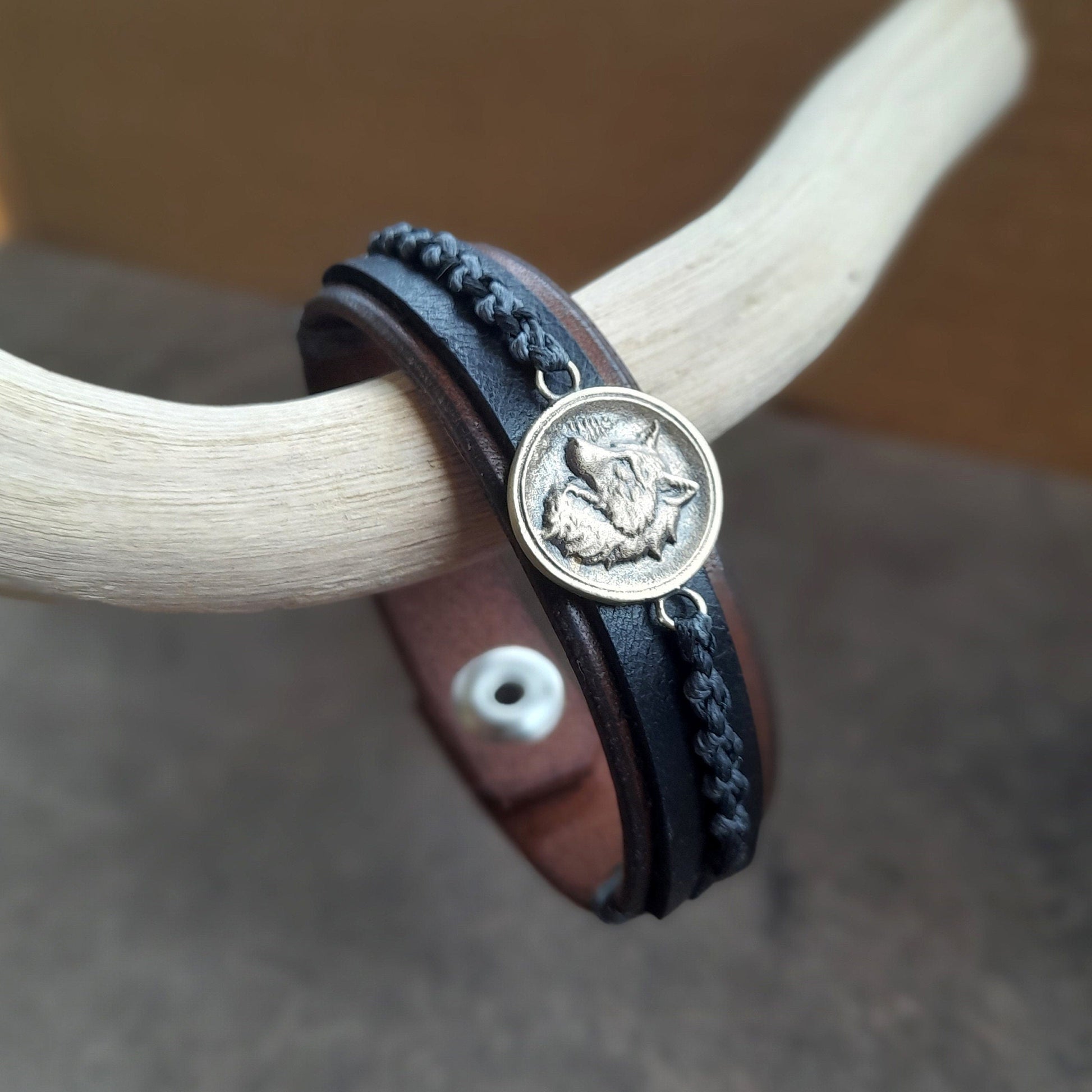 Close Side view of Great Nordic Wolf Leather Bracelet, revealing the two layers of dark brown and black full-grain leather and the craftsmanship of the bracelet's construction.