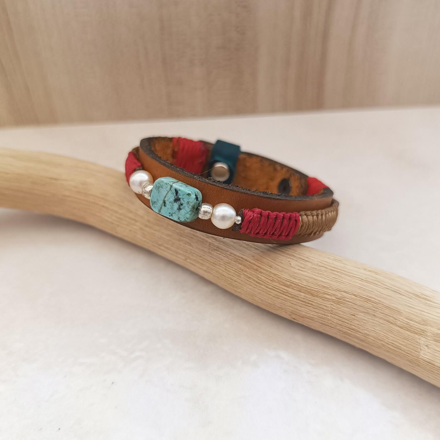 Close up of the African Turquoise Bracelet with its pearls and braided cords.