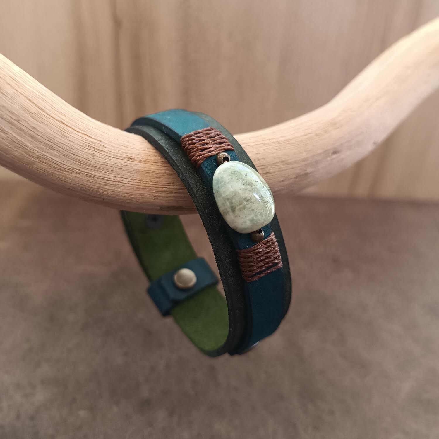 Close up of the Moss green and petrol blue leather bracelet with Bowenite stone centerpiece
