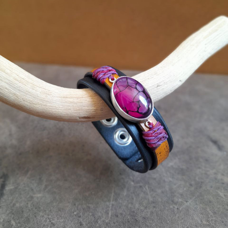 Close up side view of The Dragon Heart Bracelet: An OOAK leather cuff featuring a large Natural Purple Dragon Veins Agate cabochon set in hand-crafted Sterling Silver. Shows the full two-layered leather band.