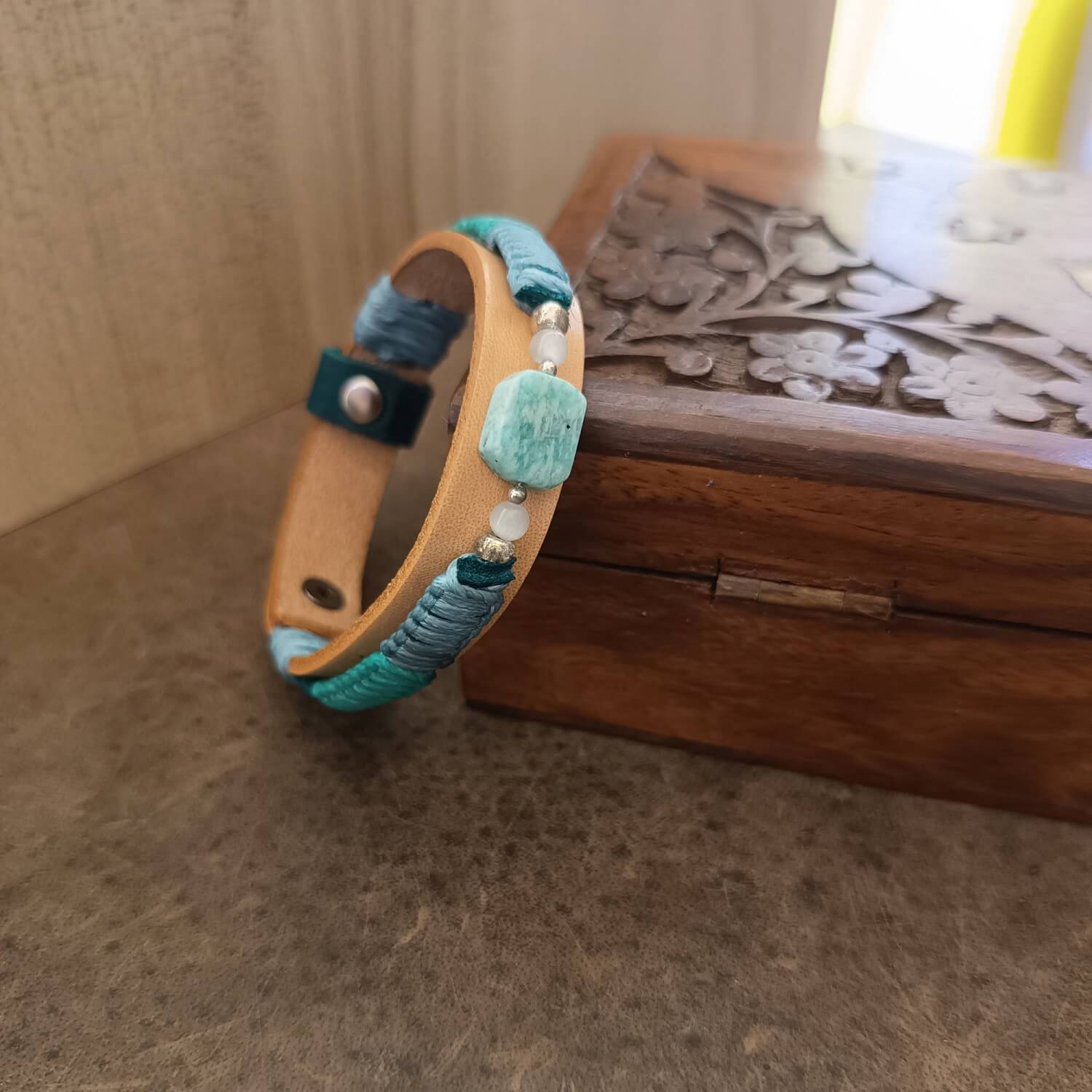 Side view of Amazonite leather bracelet showing blue and cream macramé braid