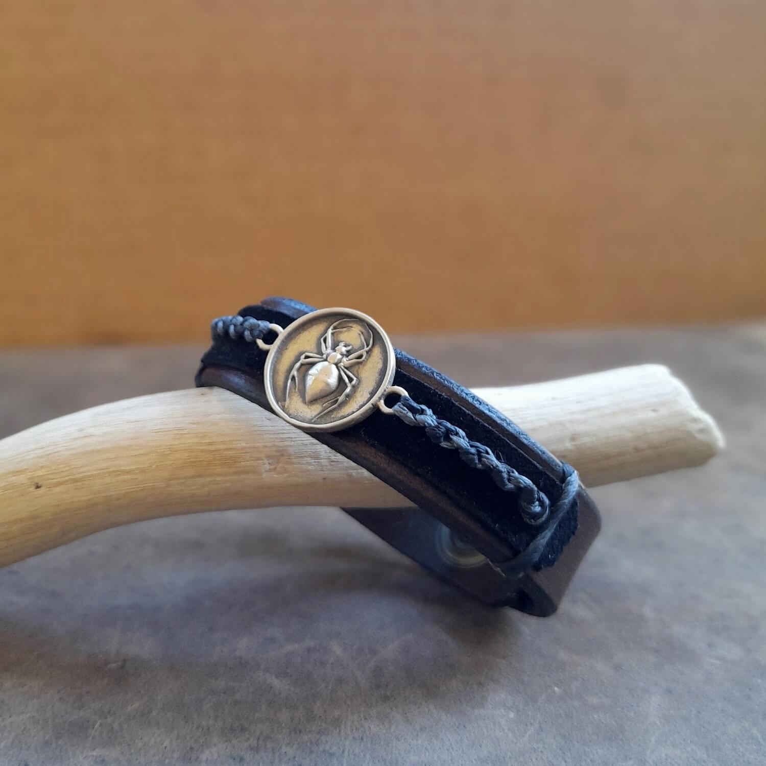 Detailed close-up of the hand-crafted oxidized brass spider pendant on the bracelet, highlighting its design and tarnish-resistant finish, emphasizing its symbolic nature.