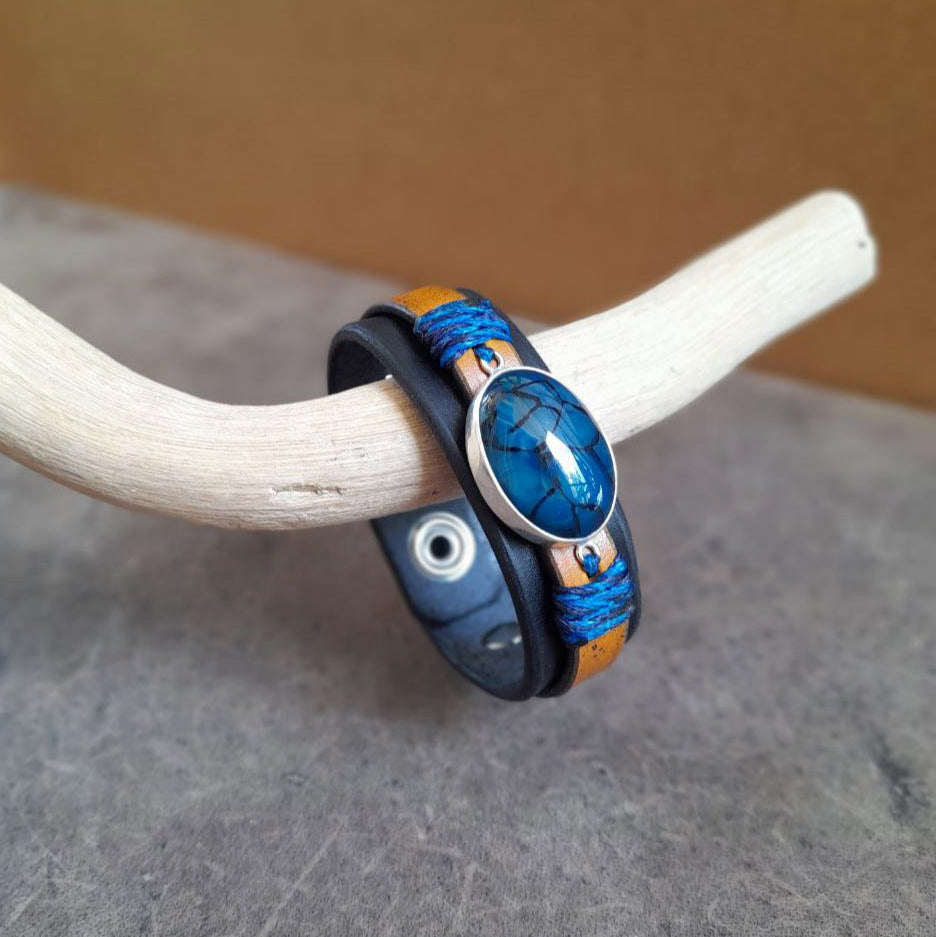 Detailed close-up side view of the natural Blue Dragon Veins Agate stone on The Dragon Whisperer Bracelet, showcasing its intricate, web-like patterns resembling dragon scales, set in sterling silver.