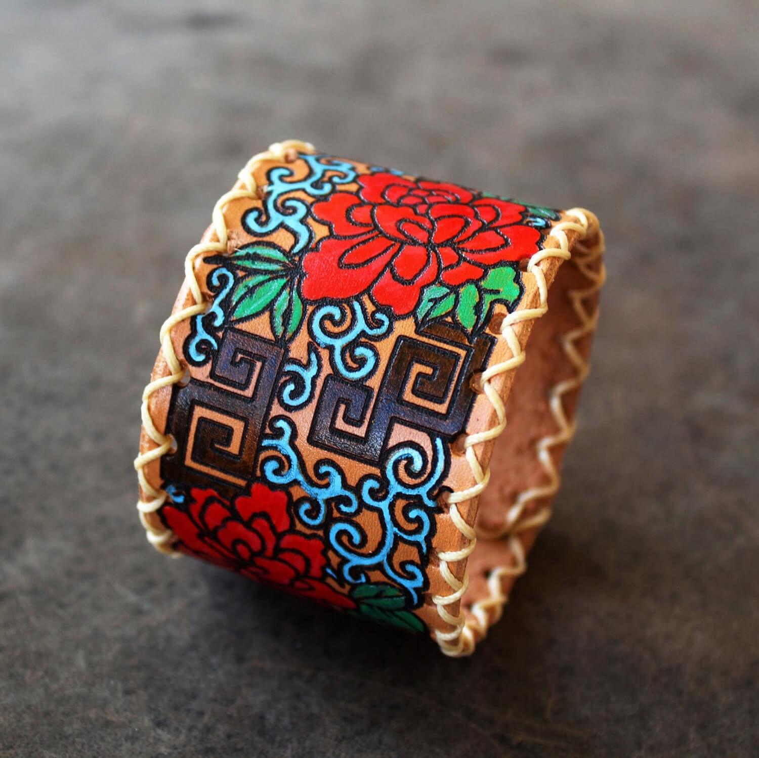 Extra wide leather cuff with hand painted Japanese floral abstract design side view close up