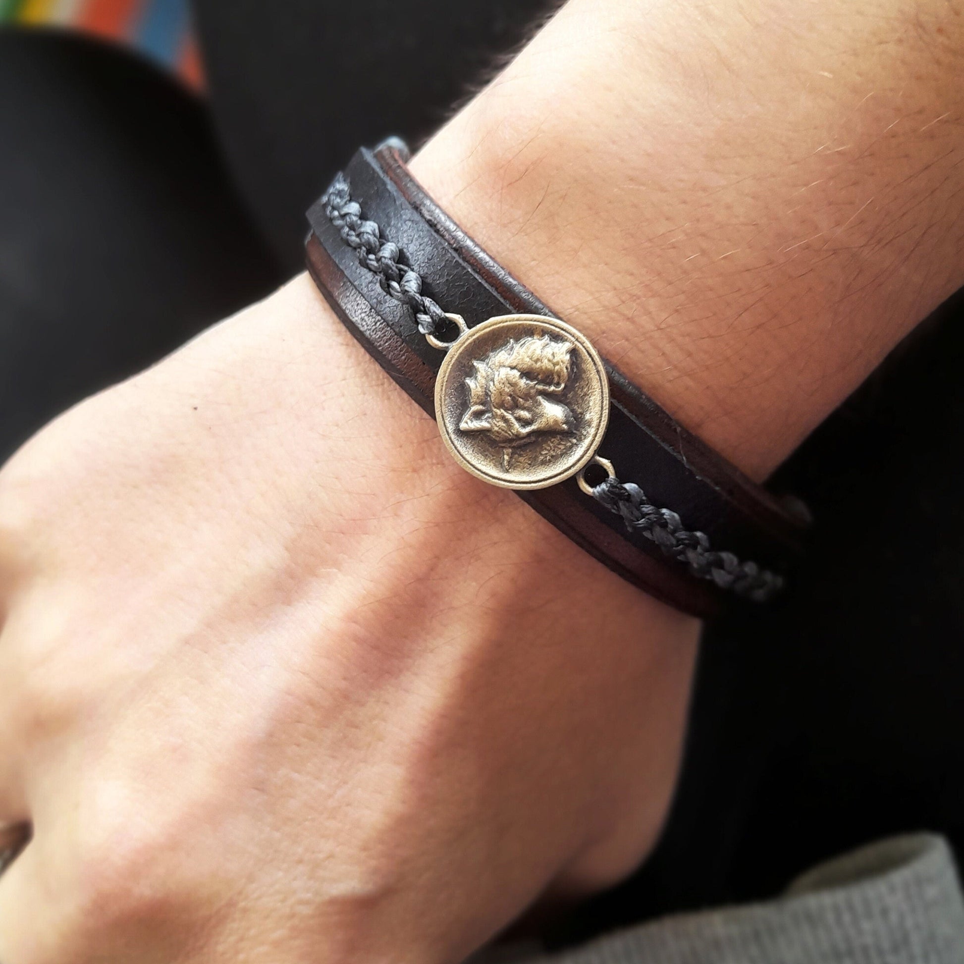 Great Nordic Wolf Leather Bracelet worn on a wrist, showcasing its wide, elegant profile and the powerful wolf pendant, making a strong style statement. Handmade by Lucky Seven Leather.