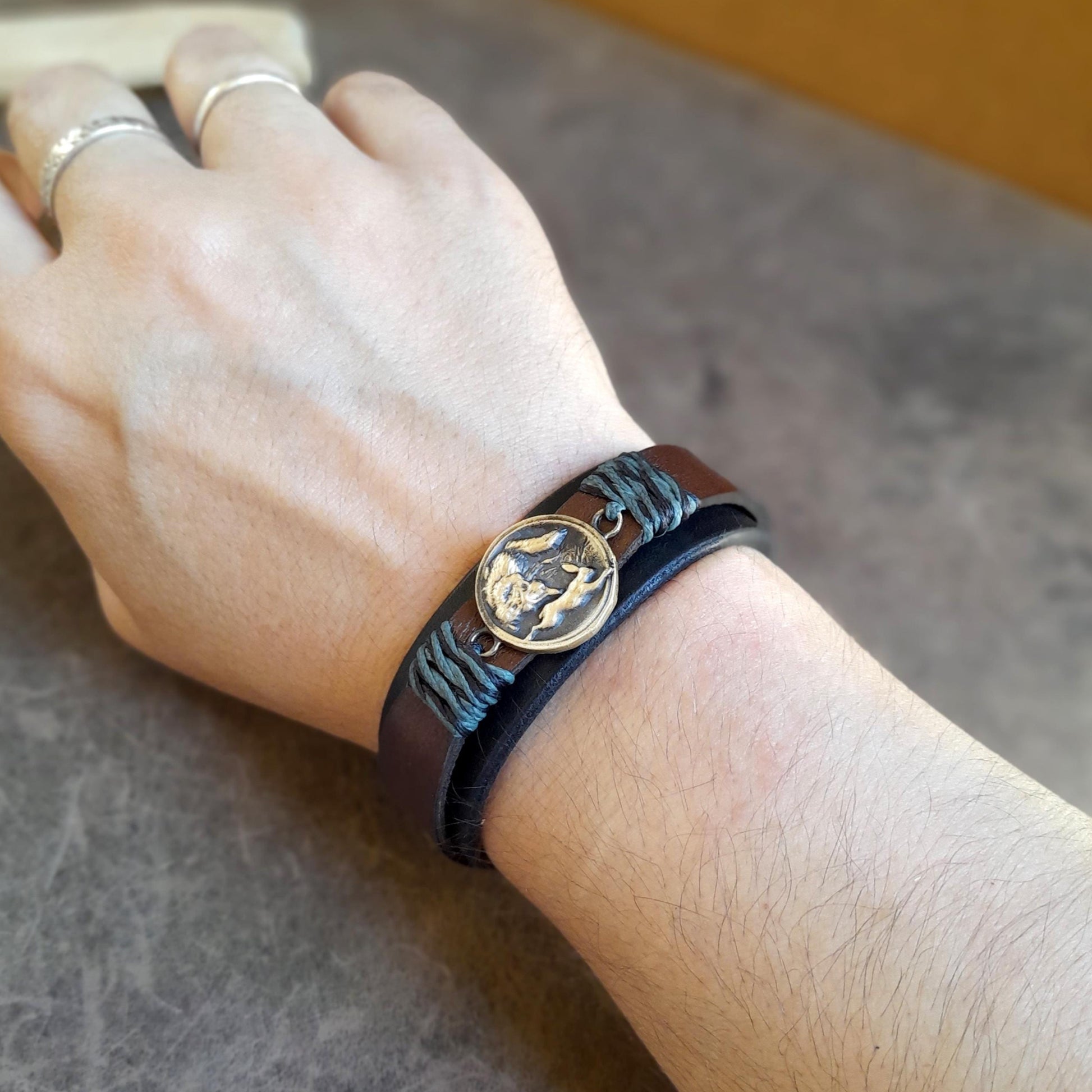 Hunting Wolf cuff bracelet worn on wrist, rugged and symbolic accessory