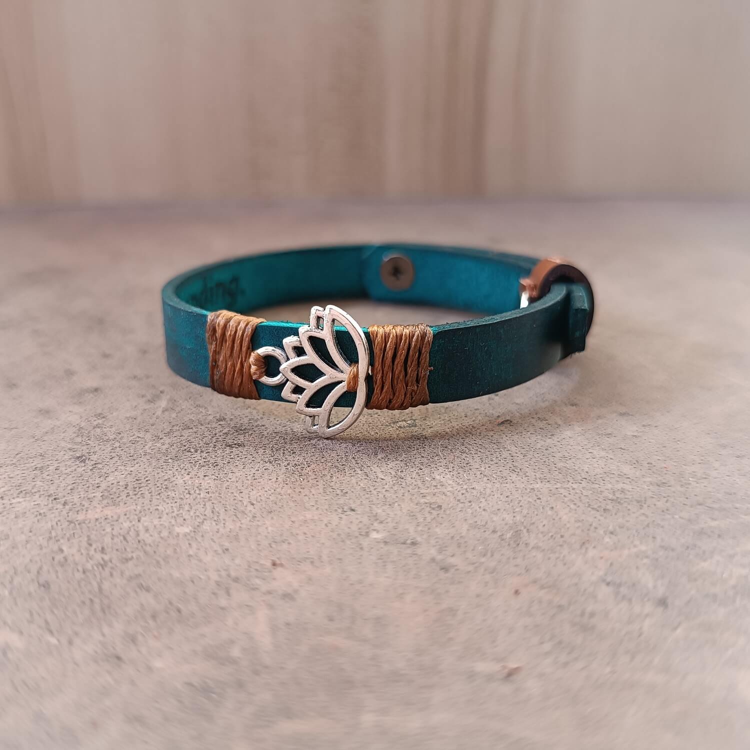 Inner Anchor Bracelet - Blue Lotus design. Handcrafted on petrol blue Crazy Horse leather, symbolizing healing and transformation, side view with partial view of secret engraved area.