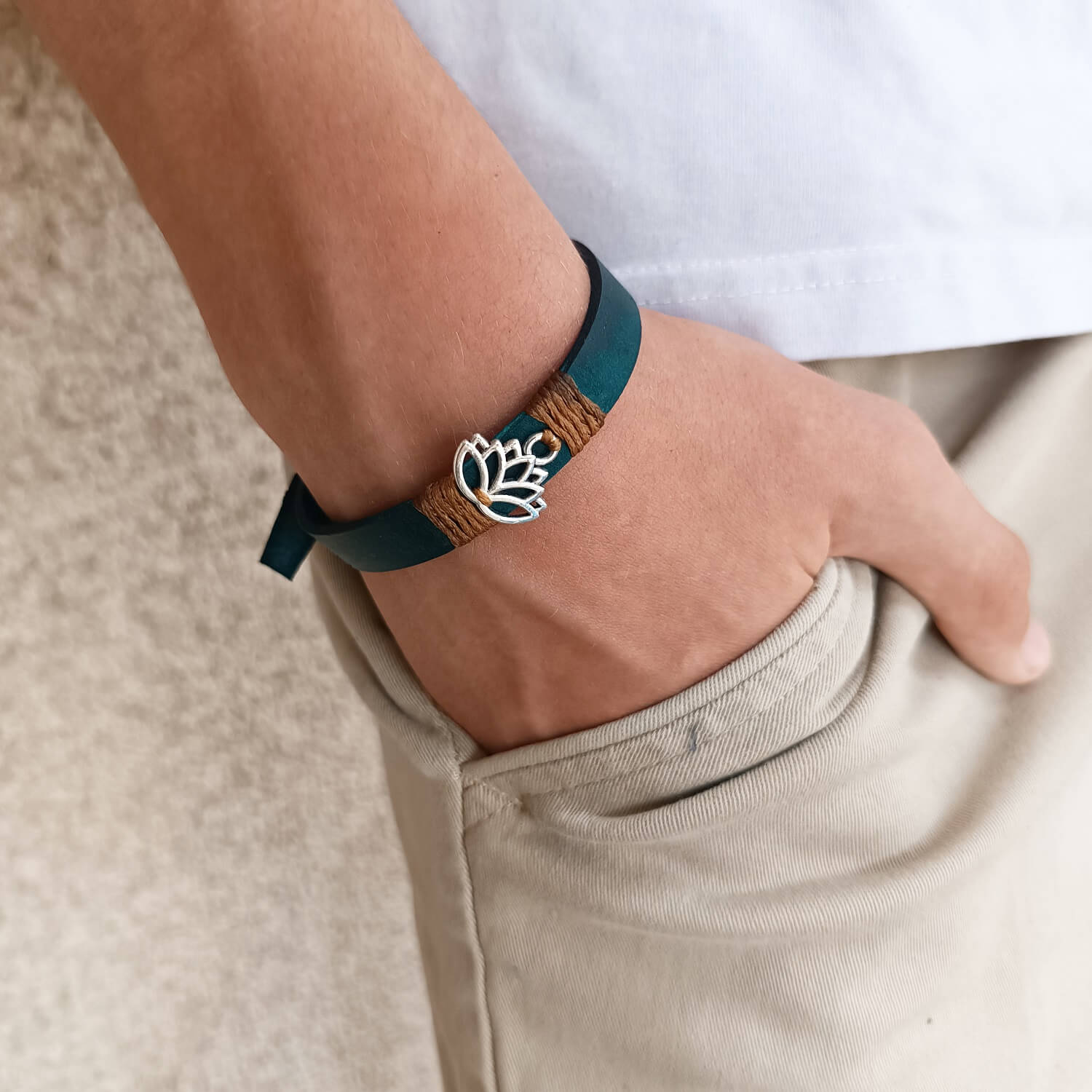 Inner Anchor Bracelet - Blue Lotus design. Handcrafted on petrol blue Crazy Horse leather, symbolizing healing and transformation, worn on wrist.