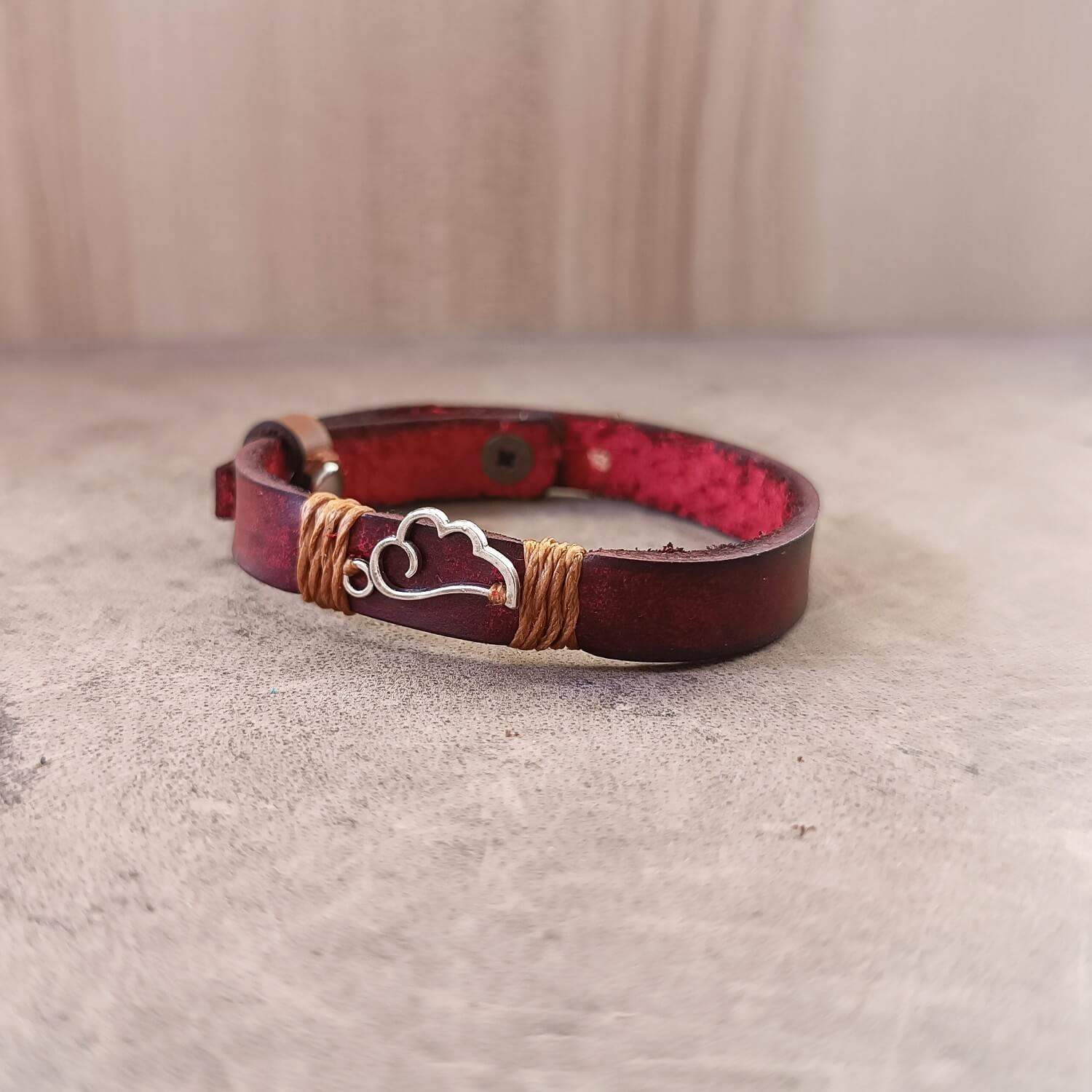 Inner Anchor Bracelet - Phoenix Wing design. Handcrafted on fiery red Crazy Horse leather, symbolizing new beginnings and transformed power, close-up.