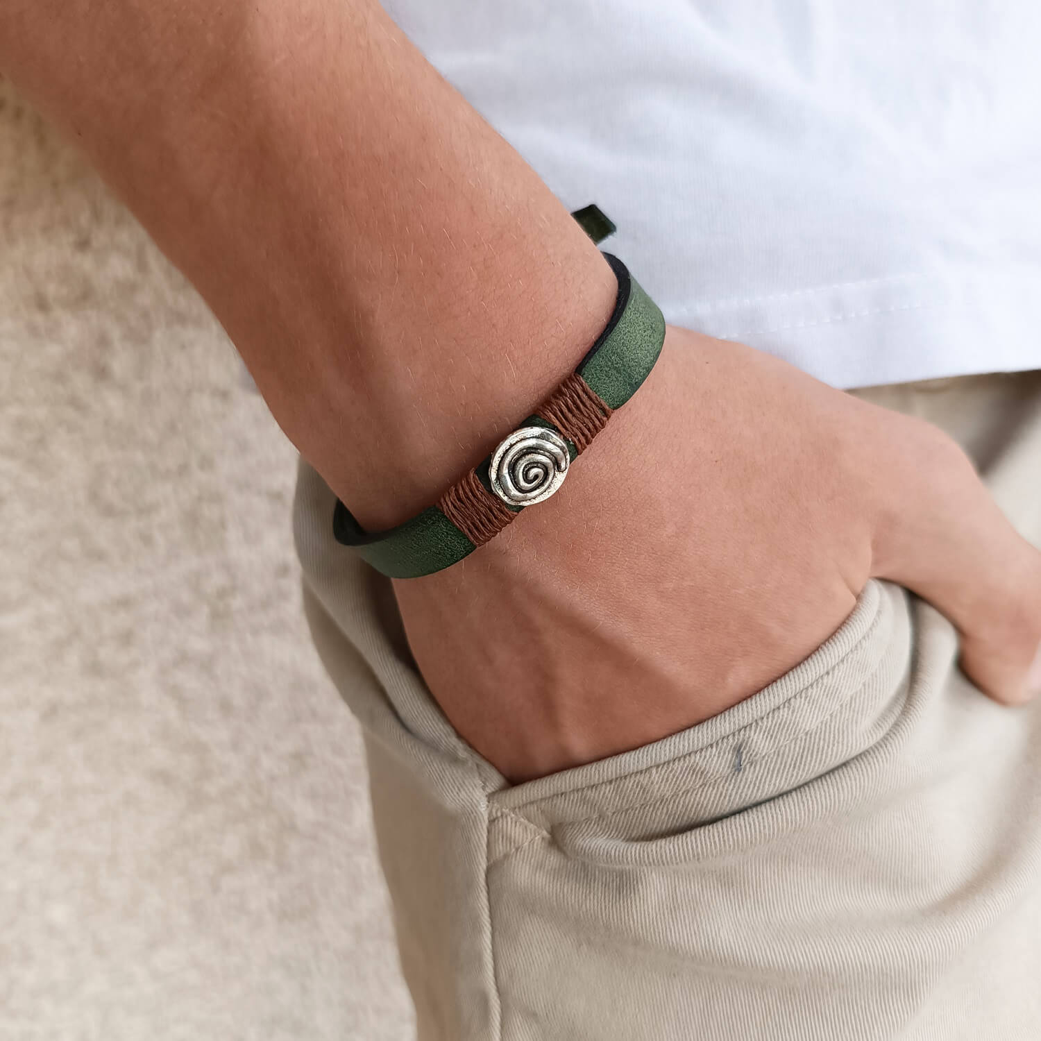 Inner Anchor Bracelet - Spiral design. Handcrafted on olive green Crazy Horse leather, symbolizing growth and inner journey, worn on wrist.