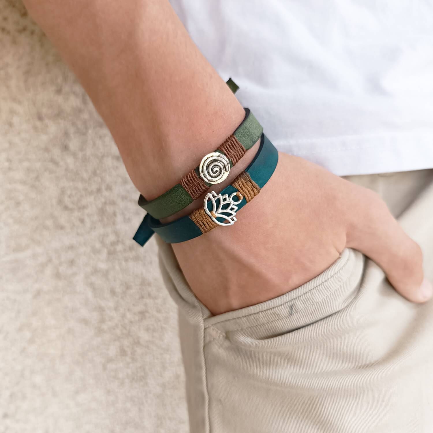 Inner Anchor Bracelets - Blue Lotus design and Spiral, both worn on wrist for a stacking appeal. Handcrafted on petrol blue and olive green Crazy Horse leather, symbolizing healing and transformation, growth and inner journey.
