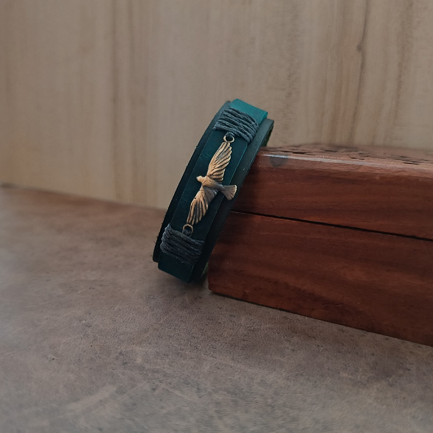 Side angle of the handmade Inzaghi Edition bracelet highlighting the layered texture of the black/green and petrol blue leather strips. The industrial gray cord wraps and adjustable closure emphasize the bracelet’s quiet grit and durable craftsmanship.