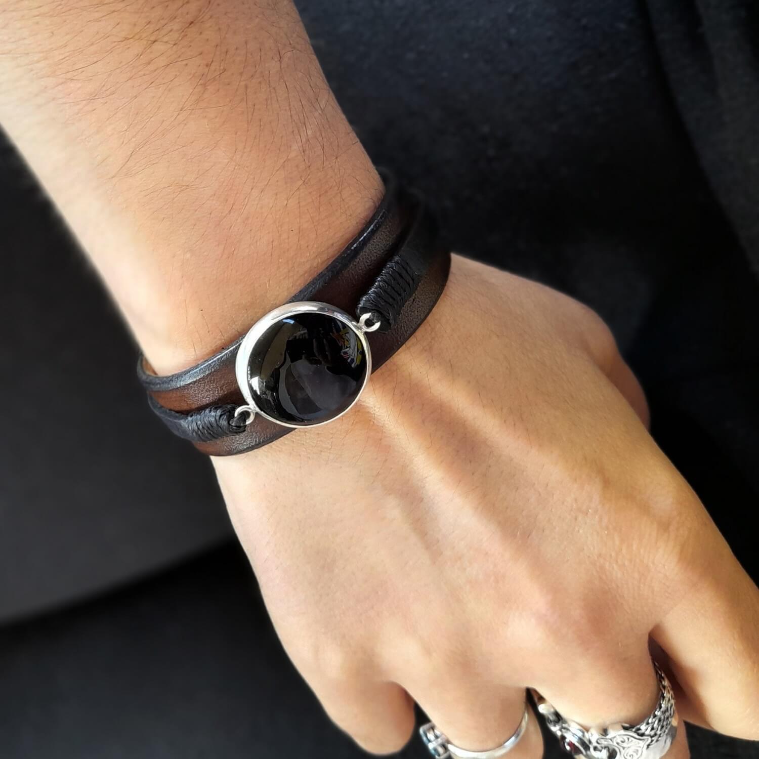 The Large Black Obsidian Leather Cuff worn on a wrist, demonstrating its substantial size, elegant fit, and versatile appeal for men and women.