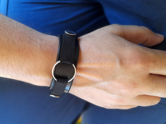 Leather Ring Holder Bracelet in black full-grain crazy horse leather, worn on wrist.