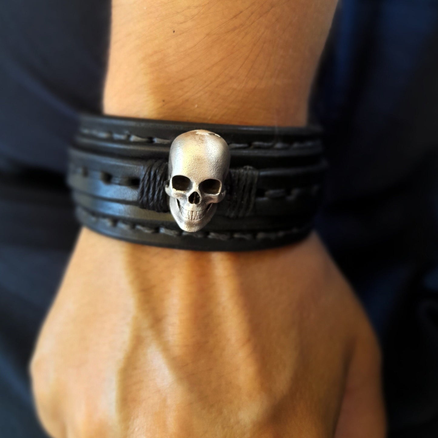 Men's Skull Leather Cuff worn on a wrist, showing comfortable fit and powerful presence.