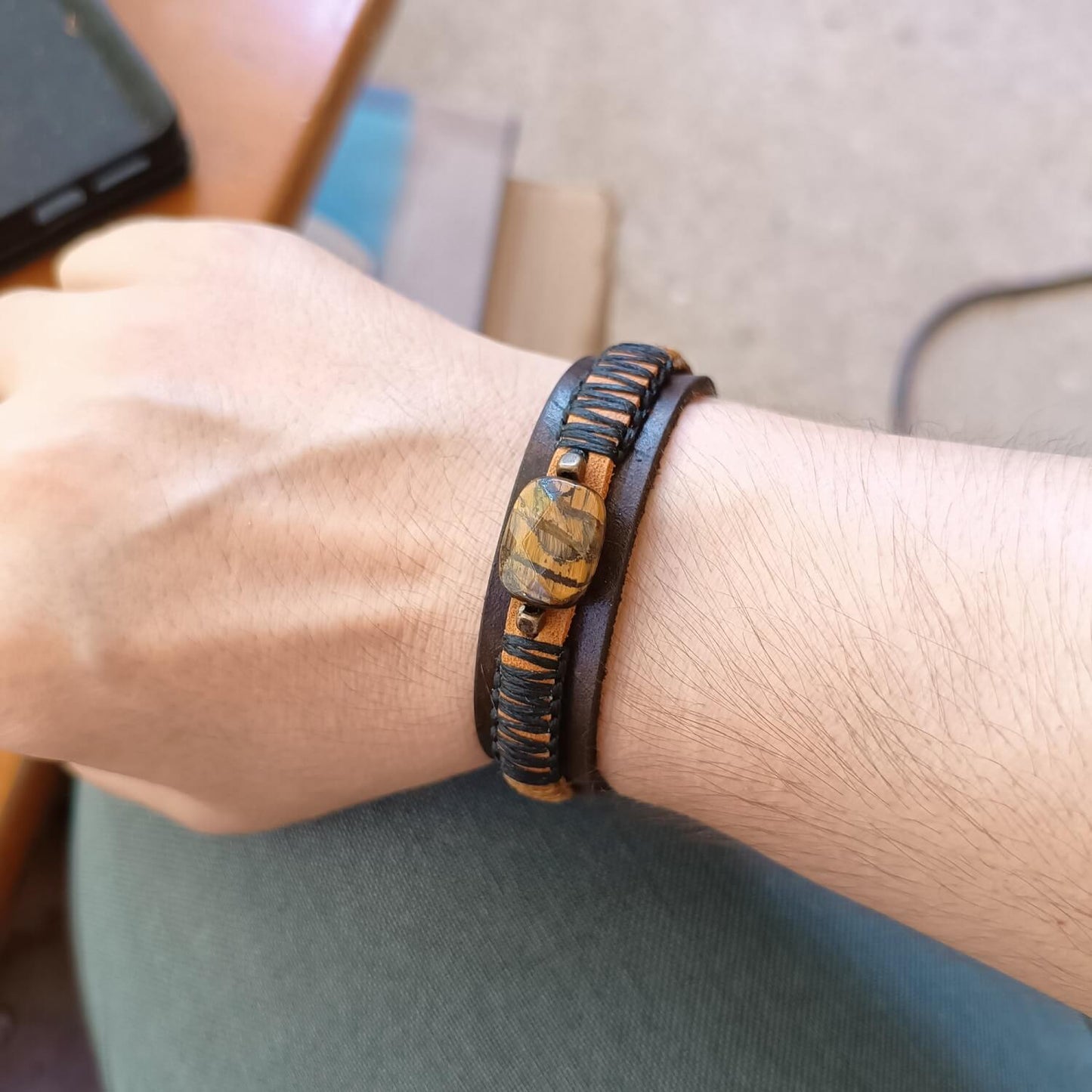 Men's tiger eye cuff worn outdoors, casual styling