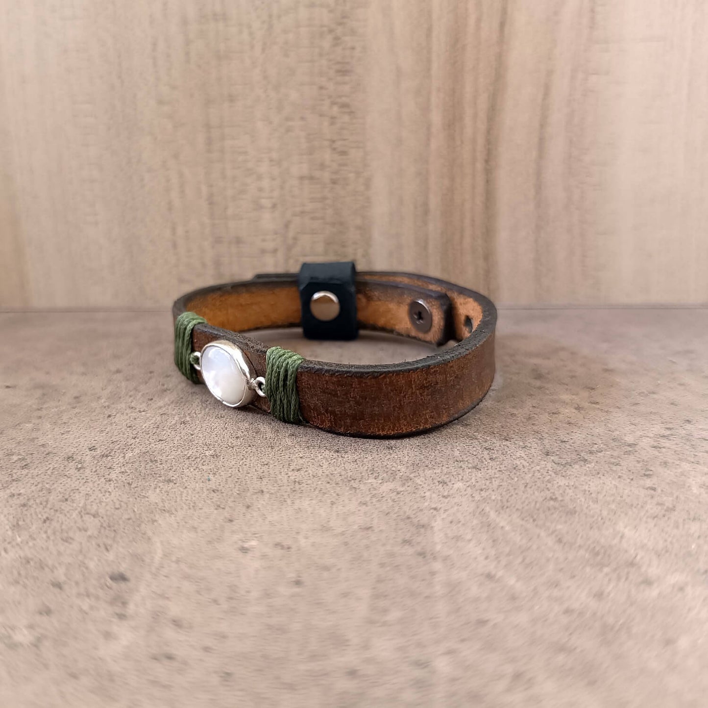 Moonstone Leather Wrap Bracelet flat view, showcasing the adjustable fit and the elegant glow of the natural moonstone against the dark brown leather. Handmade by Lucky Seven Leather.