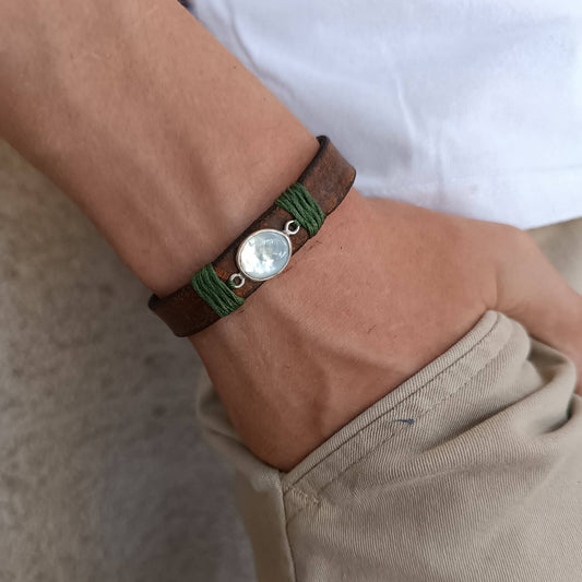 Moonstone Leather Wrap Bracelet worn on a wrist, showcasing the adjustable fit and the elegant glow of the natural moonstone against the dark brown leather. Handmade by Lucky Seven Leather.