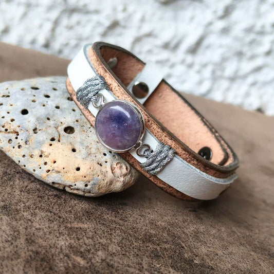 close up side view of tan and icy white handmade leather bracelet with amethyst