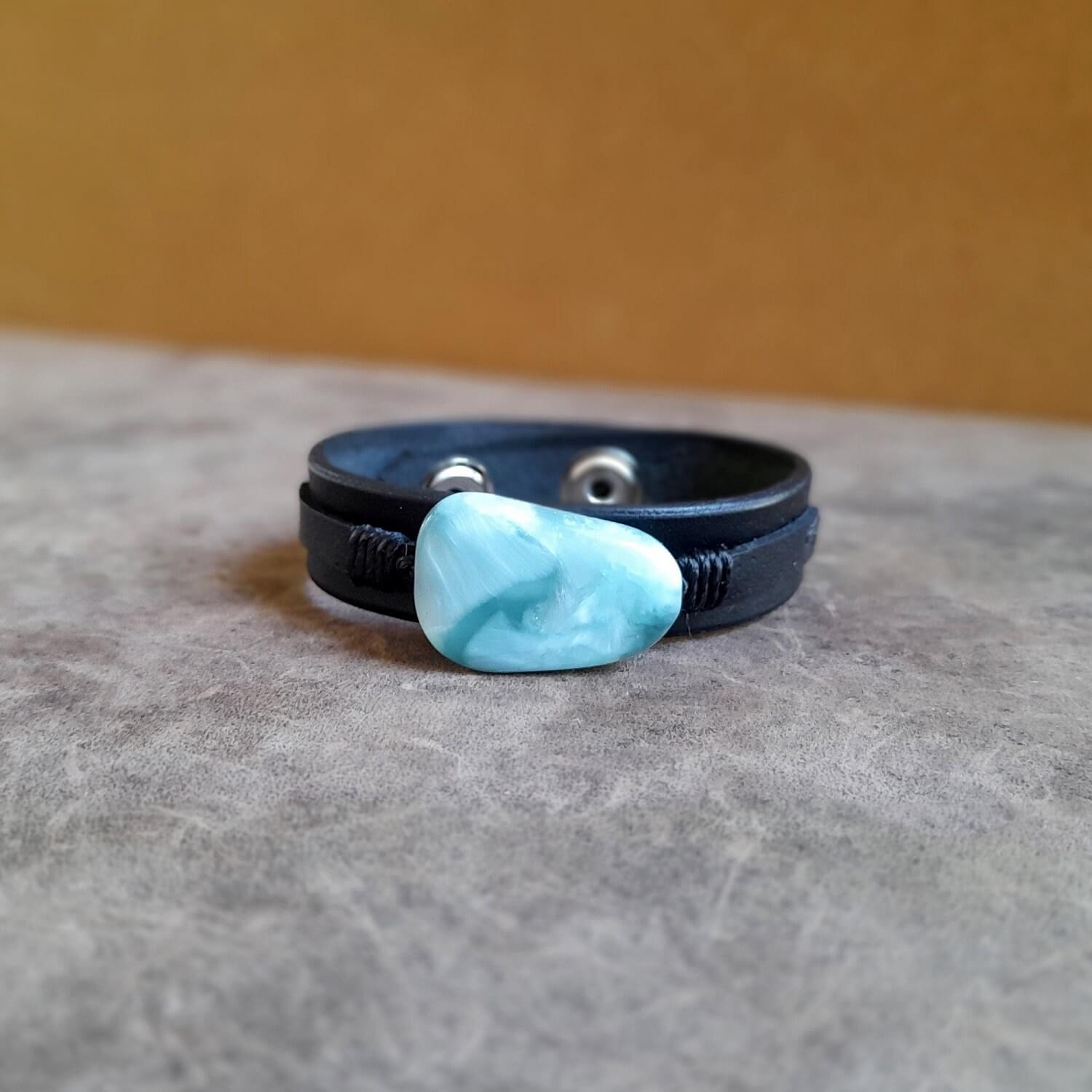 The OOAK Green Angelite Black Leather Bracelet: A layered black Vachetta leather cuff featuring a prominent irregular-shaped natural green Angelite stone.