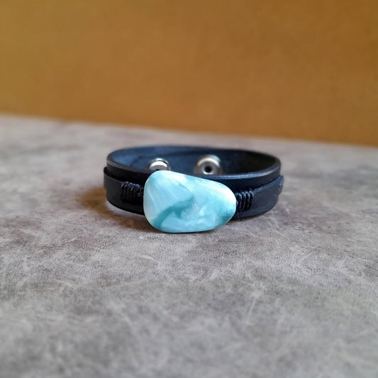 The OOAK Green Angelite Black Leather Bracelet: A layered black Vachetta leather cuff featuring a prominent irregular-shaped natural green Angelite stone.