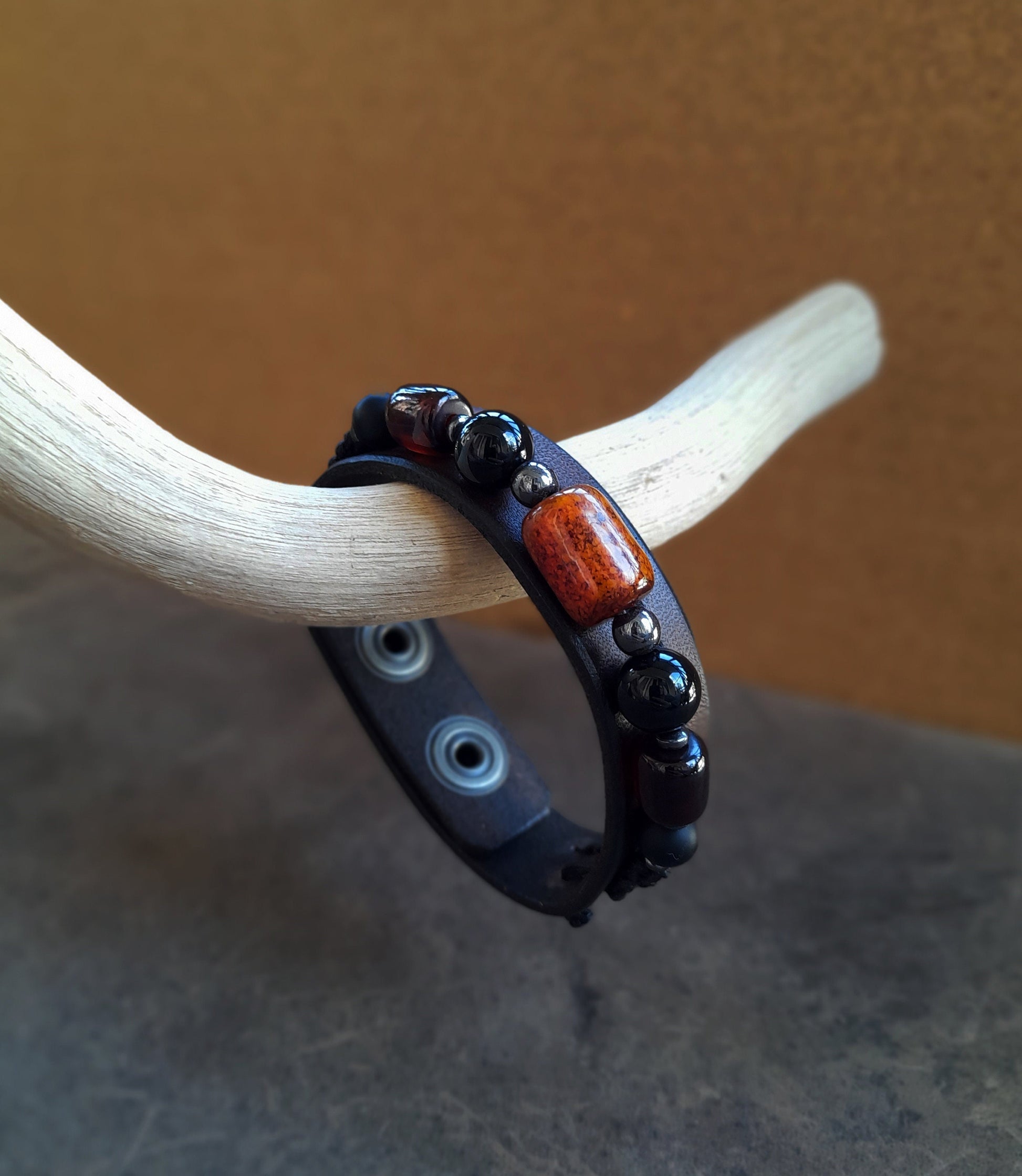 Other Close-up side view of The Earth & Sky Harmony Bracelet, highlighting the thickness of the chestnut brown Crazy Horse leather and the contrasting natural Black Onyx and Amber barrel beads.