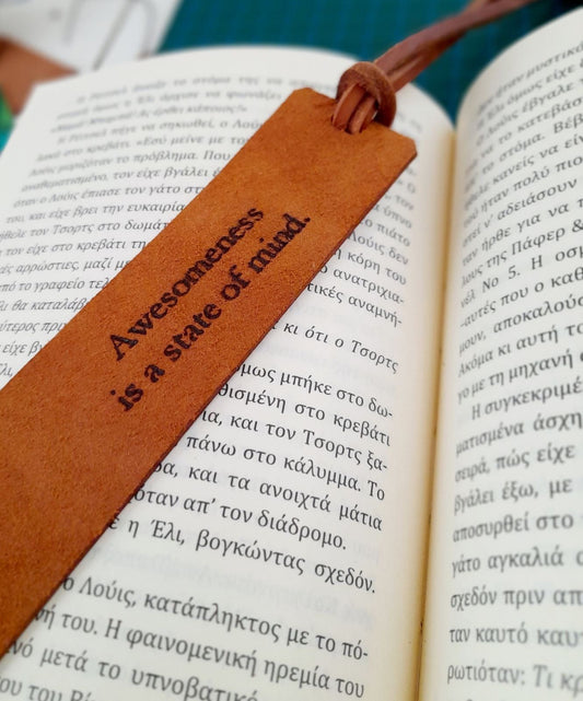 Personalized Birthflower Leather Bookmark (backside with custom text) placed inside an open book, showing how it looks during use.