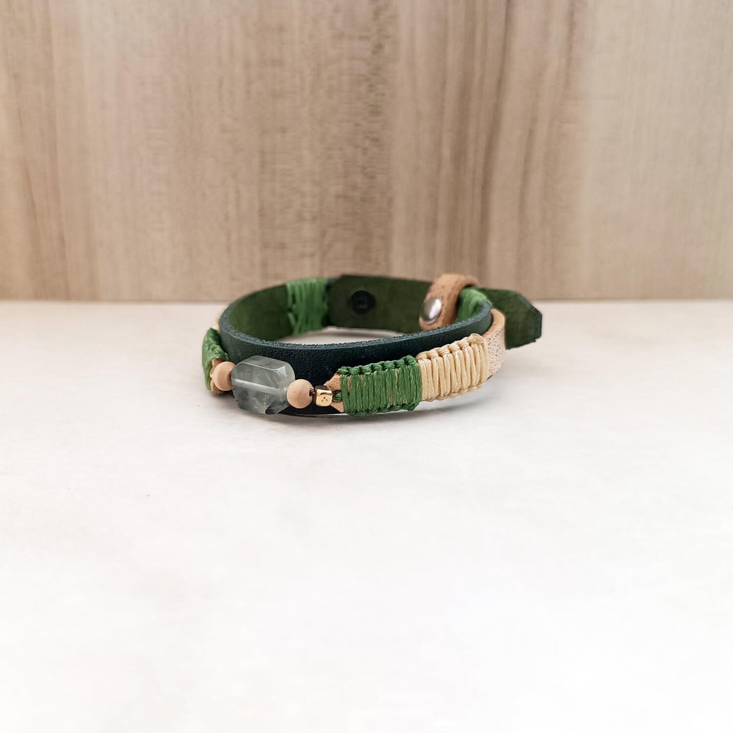 Prehnite gemstone leather bracelet with green and cream braid – front side view on white marble showing beautiful contrast